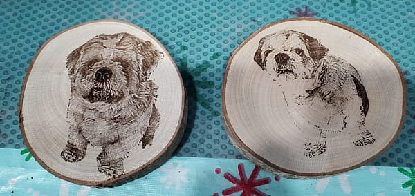 small dogs laser engraved on wood puck