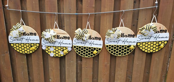 multiple round bee themed wood signs