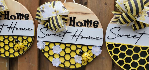 Yellow metal bee on a wood sign with black lettering