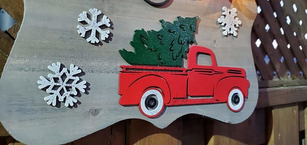 red truck with a green Christmas tree in the back