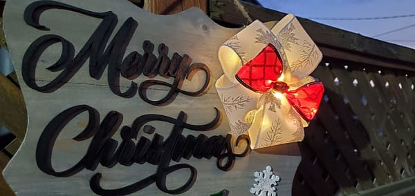 bow with lights on Christmas sign